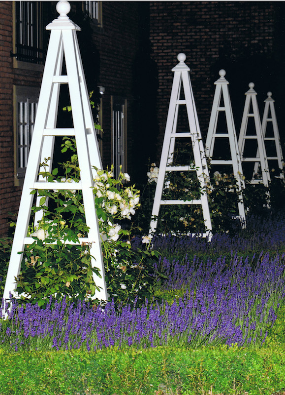 Nighttime photo of 5 large Painted Wooden Garden Obelisks at The Belfry Hotel, these were made in 2013 and painted to a RAL code colour