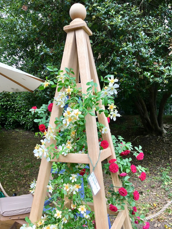 Oak Obelisk with vibrant red roses of Chevy Chase and the beautifully scented white flowers of Wedding Day rambling roses on our trade stand at RHS Chelsea Flower Show 2018