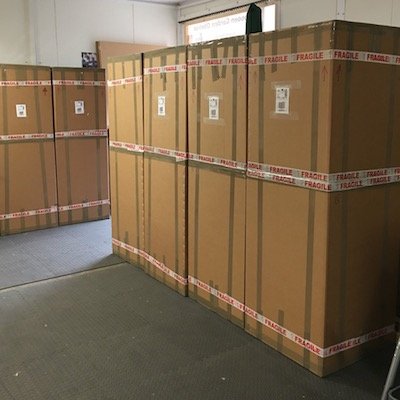 6 obelisks packed into heavy duty large cardboard boxes waiting for delivery